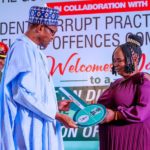 President Muhammadu Buhari presenting the ICPC Integrity award to Ms. Josephine Ugwu