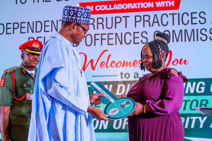 President Muhammadu Buhari presenting the ICPC Integrity award to Ms. Josephine Ugwu