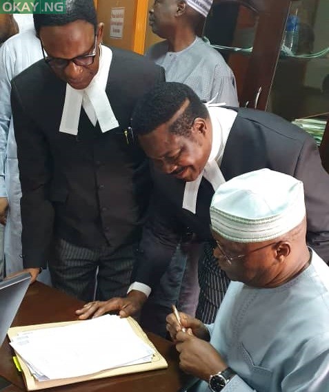 Atiku Abubakar sign his deposition in support of a N2.5 billion libel suit against an aide to President Muhammadu Buhari, Lauretta Onochie