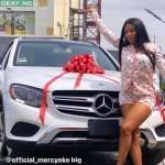 Mercy Eke poses in front of her new Mercedes Benz