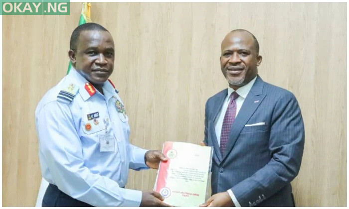 Chief Executive Officer of AIB, Engr Akin Olateru (right) hands over the interim report to Chief of Air Staff (CAS), Air Marshal Amao (left)