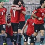 Egypt’s players celebrate their second goal during the Africa Cup of Nations (CAN) 2021 quarter-final football match between Egypt and Morocco at Stade Ahmadou Ahidjo in Yaounde on January 30, 2022. (Photo by Kenzo Tribouillard / AFP)