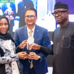 Minister of Trade and Investment, Otunba Niyi Adebayo (left) presenting the award to the Group Executive Director, Commercial Operations, Dangote Industries Limited, Halima Aliko-Dangote (left) and the Group Managing Director, Dangote Sugar Refinery Plc, Ravindra Singhvi (middle)