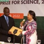 Member of the Advisory Board for NLNG-sponsored The Nigeria Prize for Science, Chief Dr. Nike Akande, hands over the 2022 entries to the Chairman, panel of judges for this year's competition, Professor Christian Ugwu Agbo, at a ceremony in Lagos today.