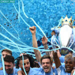 Manchester City’s Brazilian midfielder Fernandinho lifts the Premier League trophy as City players celebrate on the pitch after the English Premier League football match between Manchester City and Aston Villa at the Etihad Stadium in Manchester, north west England, on May 22, 2022. Oli SCARFF / AFP