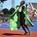 Nigeria’s Tobi Amusan celebrates winning and taking the gold medal in the women’s 100m hurdles final athletics event at the Alexander Stadium, in Birmingham on day ten of the Commonwealth Games in Birmingham, central England, on August 7, 2022. (Photo by Ben Stansall / AFP)