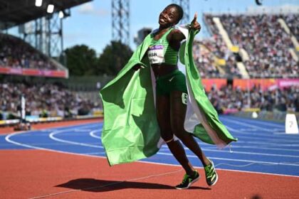 Nigeria’s Tobi Amusan celebrates winning and taking the gold medal in the women’s 100m hurdles final athletics event at the Alexander Stadium, in Birmingham on day ten of the Commonwealth Games in Birmingham, central England, on August 7, 2022. (Photo by Ben Stansall / AFP)