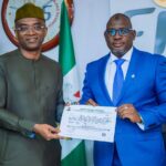 Executive Chairman, FIRS, Muhammad Nami with Deputy Managing Director, NLNG, Mr. Olalekan Ogunleye showing Tax Credit Certificate handed to NLNG for the construction of the Bonny - Bodo Road and Bridge, Rivers State. 18th August 2022.