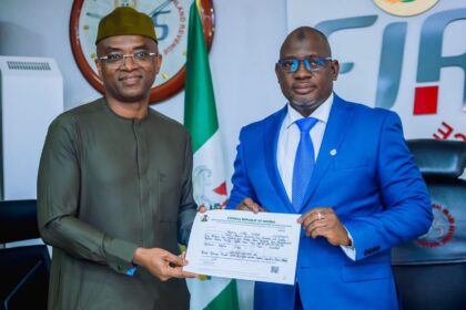 Executive Chairman, FIRS, Muhammad Nami with Deputy Managing Director, NLNG, Mr. Olalekan Ogunleye showing Tax Credit Certificate handed to NLNG for the construction of the Bonny - Bodo Road and Bridge, Rivers State. 18th August 2022.