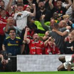 Manchester United’s English striker Marcus Rashford (R) celebrates in front of supporters after scoring their second goal during the English Premier League football match between Manchester United and Liverpool at Old Trafford in Manchester, north west England, on August 22, 2022. (Photo by Paul ELLIS / AFP)