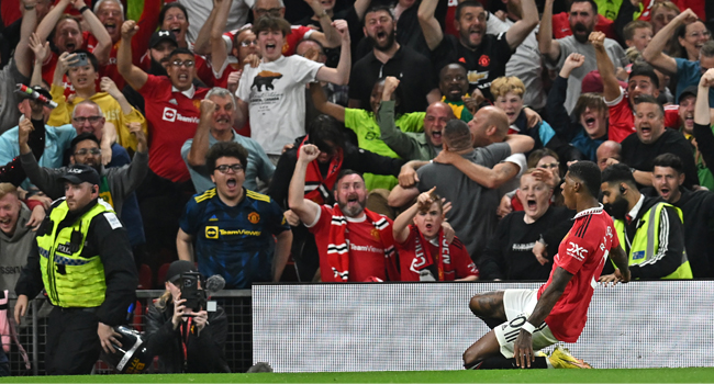 Manchester United’s English striker Marcus Rashford (R) celebrates in front of supporters after scoring their second goal during the English Premier League football match between Manchester United and Liverpool at Old Trafford in Manchester, north west England, on August 22, 2022. (Photo by Paul ELLIS / AFP)