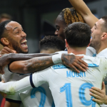 Chelsea’s Gabonese striker Pierre-Emerick Aubameyang (L) celebrates with his teammates after scoring his team’s second goal during the UEFA Champions League group E, football match between AC Milan and Chelsea, at the San Siro stadium, in Milan, on October 11, 2022. (Photo by Alberto PIZZOLI / AFP)