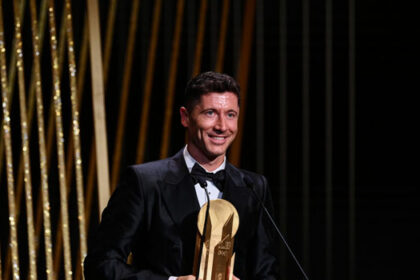 Bayern Munich’s Polish forward Robert Lewandowski receives for the second time the Gerd Muller Trophy for the best striker during the 2022 Ballon d’Or France Football award ceremony at the Theatre du Chatelet in Paris on October 17, 2022. (Photo by FRANCK FIFE / AFP)