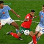 Morocco’s midfielder #21 Walid Cheddira fights for the ball with Spain’s midfielder #16 Rodri and Spain’s defender #24 Aymeric Laporte during the Qatar 2022 World Cup round of 16 football match between Morocco and Spain at the Education City Stadium in Al-Rayyan, west of Doha on December 6, 2022. (Photo by MANAN VATSYAYANA / AFP)