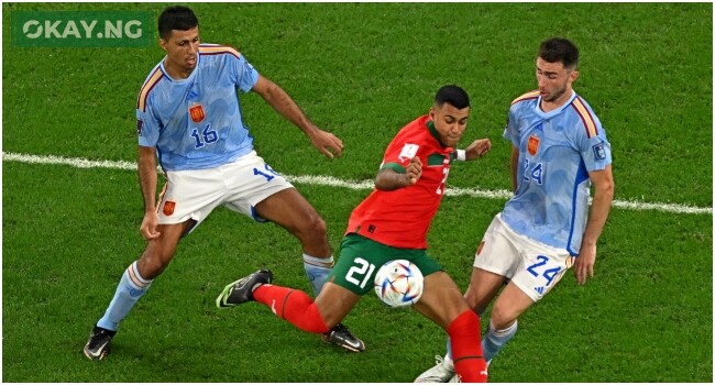 Morocco’s midfielder #21 Walid Cheddira fights for the ball with Spain’s midfielder #16 Rodri and Spain’s defender #24 Aymeric Laporte during the Qatar 2022 World Cup round of 16 football match between Morocco and Spain at the Education City Stadium in Al-Rayyan, west of Doha on December 6, 2022. (Photo by MANAN VATSYAYANA / AFP)