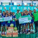 Category Manager for Beverages, Nestlé Nigeria, Mr. Olutayo Olatunji (middle) presenting the winner’s trophy to the girls from St. Jude’s Girls Secondary School Amarata Yenagoa, Bayelsa State at the Indoor Sports Hall of the Stephen Keshi Stadium Asaba recently after the girls won the girls category of the Atlantic Conference of the 23rd MILO Secondary Schools Basketball Championship