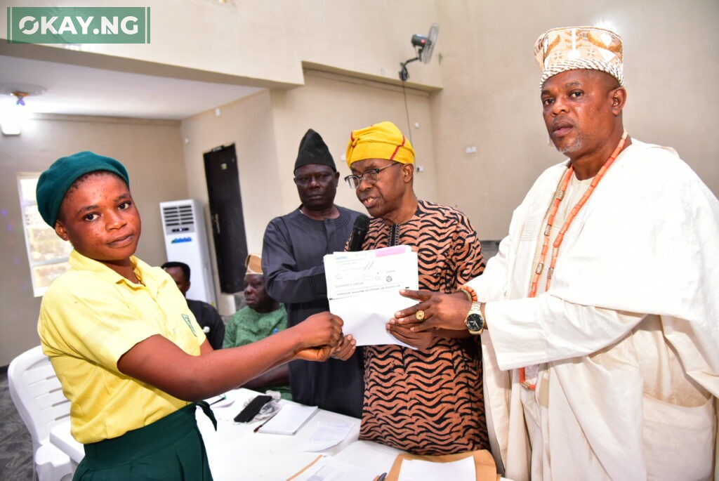 L-R, Ladi Michael Student of Sopen Comprehensive High School, Ati Basiri, Ijebu - Igbo, Receiving her Award cheque from, Pastor Joseph Alabi, General manager Community Relation, Dangote Project; Ebenezer Fola Ali, Director Human Assets Management, Dangote Projects and Oba ( Dr.) Mufutau Adesesan Yusuf, Sopen Ilukale of Oke Sopen Ijebu - Igbo Ogun state, at the Dangote Granite Mines' presentation of Students Scholarship Awards to Hosting Communities in Ijebu - Igbo Ogun state, at the weekend