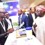 President of Federal Republic of Nigeria, Asiwaju Bola Ahmed Tinubu, discussing with Jibrin Abubakar of Dangote's corporate communications department at the Dangote stand at the ongoing 29th Nigerian Economic Summit in Abuja on 23rd October 2023.