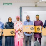 Pic.2. The DG, NITDA, Kashifu Inuwa CCIE, represented by Ag. Director, Digital Literacy and Capacity Development Department, Dr Amina Sambo-Magaji presenting laptops to the top 10 winners of the NITDA-Coursera training programme