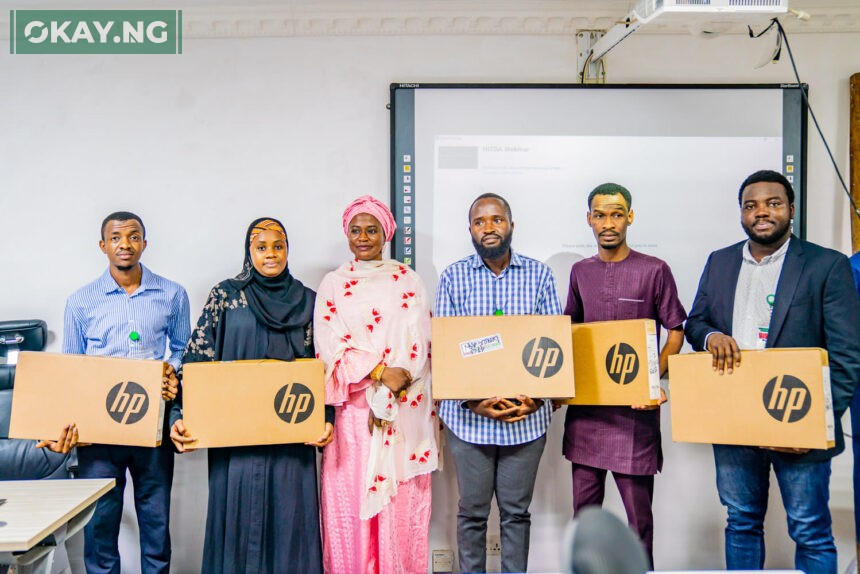 Pic.2. The DG, NITDA, Kashifu Inuwa CCIE, represented by Ag. Director, Digital Literacy and Capacity Development Department, Dr Amina Sambo-Magaji presenting laptops to the top 10 winners of the NITDA-Coursera training programme