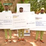 Three of the winners at Delta NYSC Orientation camp pose for a photo with their cheques after emerging as winners